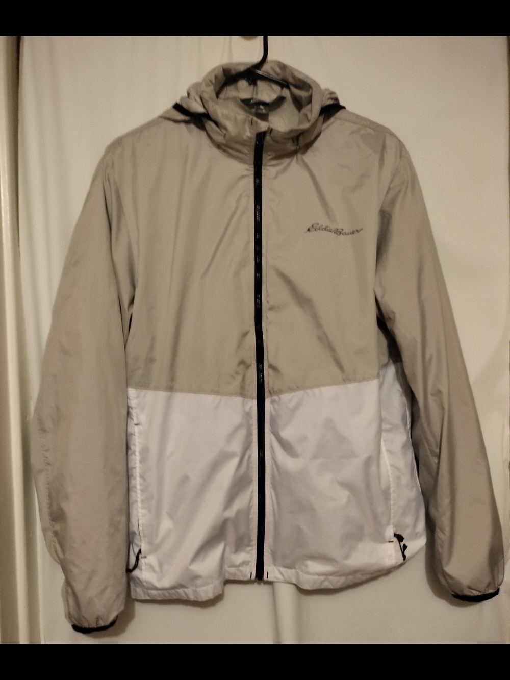 Eddie Bauer men's lightweight colorblock windbreaker jacket in gray and white.